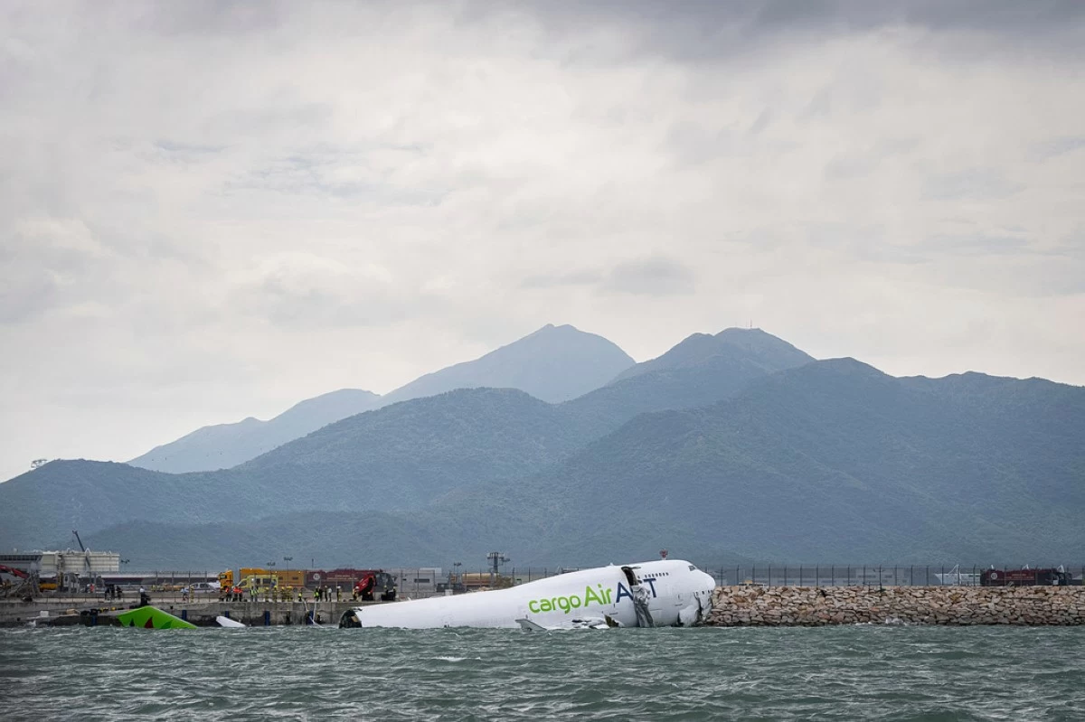 The cargo aircraft that skidded off a Hong Kong airport runway is seen on Monday, Oct. 20, 2025. (AP Photo/Chan Long Hei)