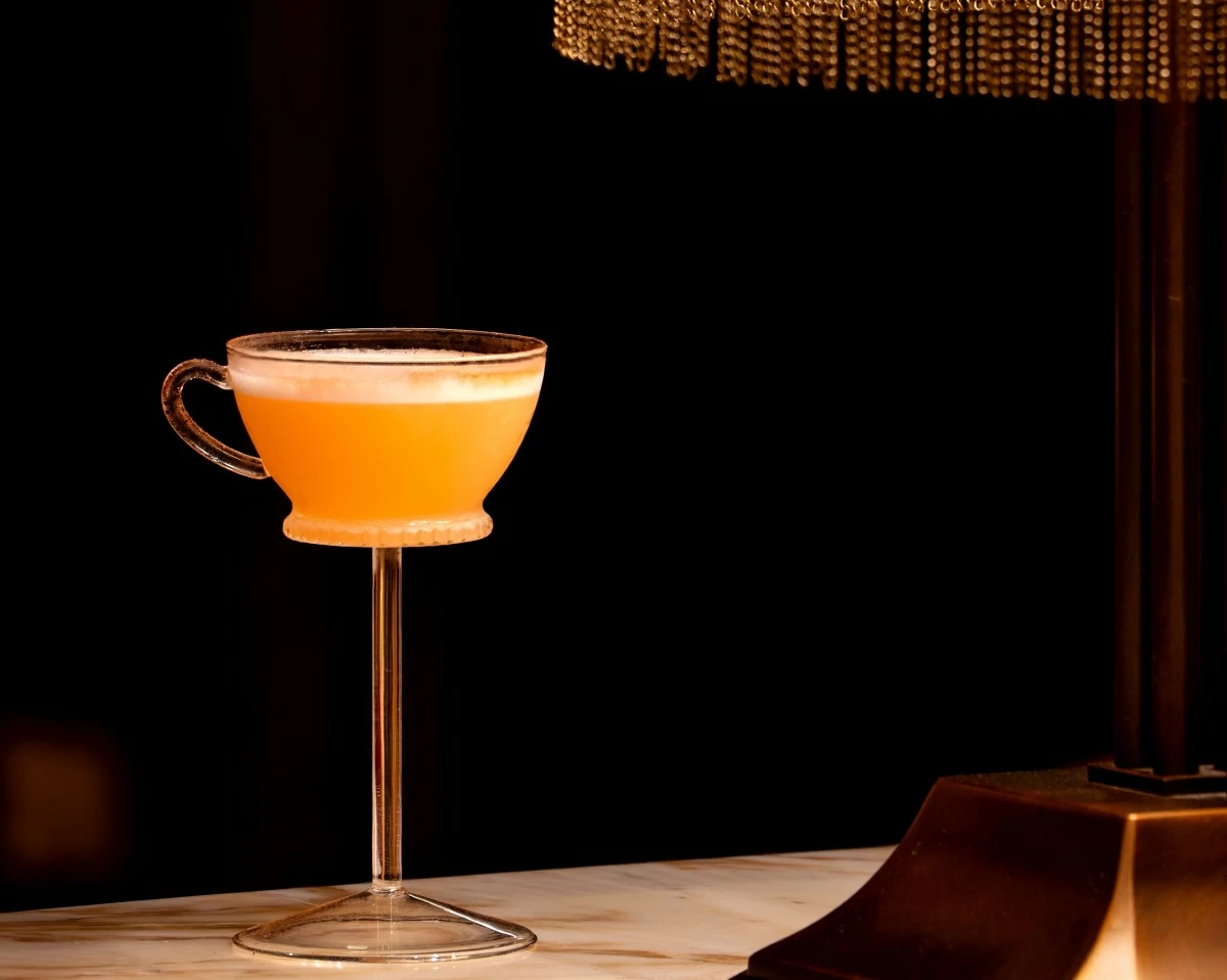 SONATA SIP A Quezon Club signature cocktail designed by Head Bartender Martin Protacio, served under warm amber lighting at the bar