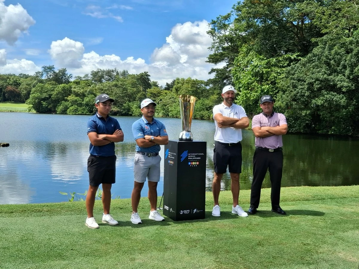 From left, Sean Ramos, Miguel Tabuena, Dustin Johnson, Patrick Reed pose with the trophy.