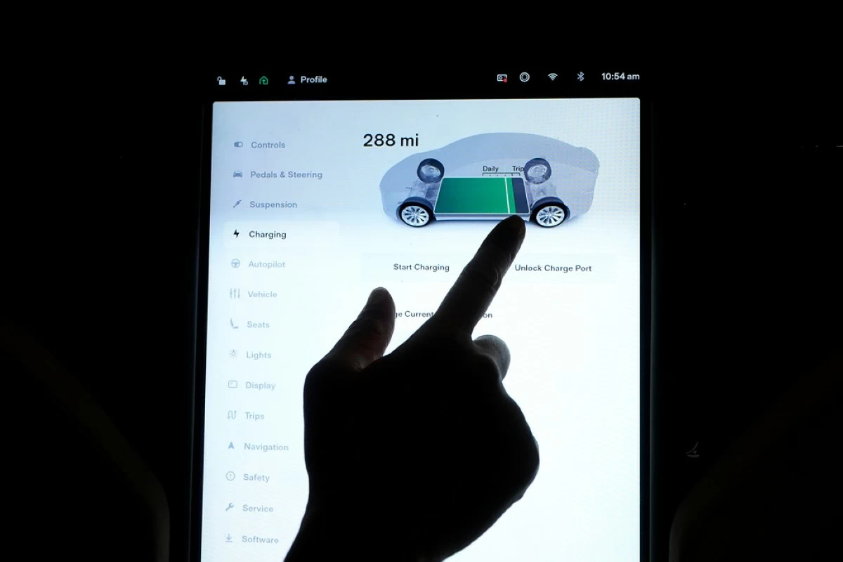FILE - The charging status screen is shown on a Tesla car at a home in San Francisco, Aug. 25, 2022. (AP Photo/Jeff Chiu, File)