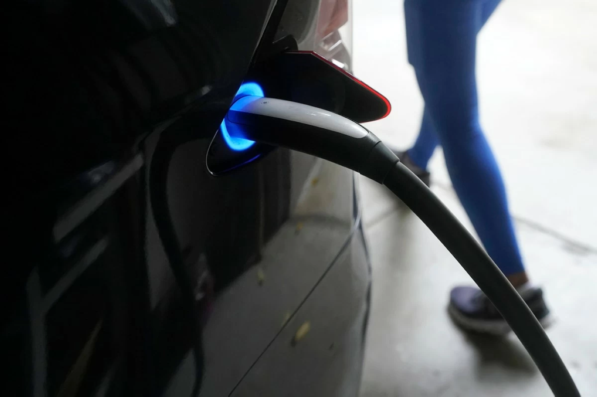 FILE - A Tesla car charges at a home in San Francisco, Aug. 25, 2022. (AP Photo/Jeff Chiu, File)