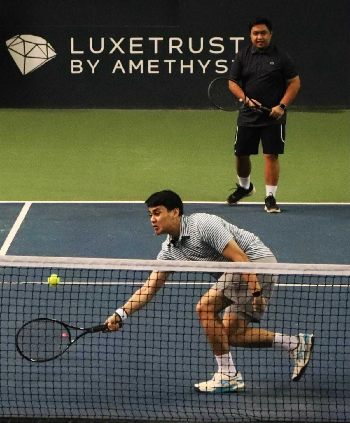 Pareng Hayb hits a drop shot during an exhibition match.