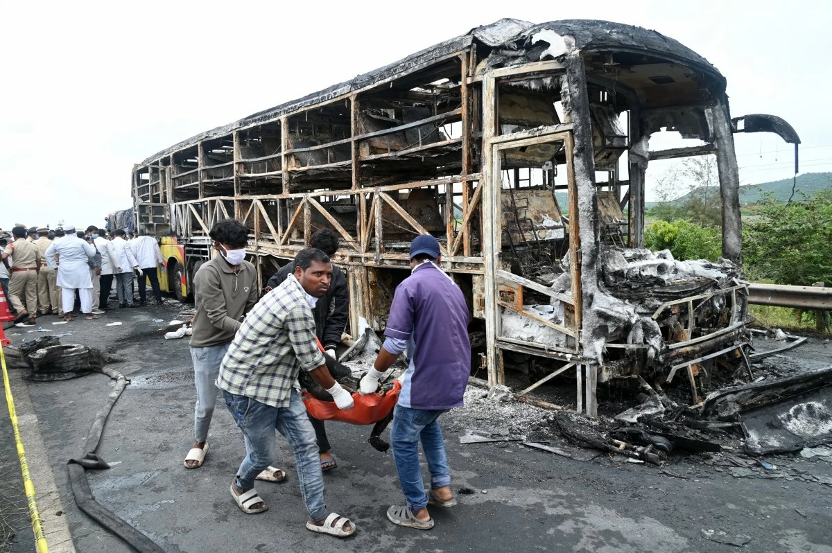 Volunteers remove a dead body from the debris of a passenger bus which caught fire early Friday after a collision with a motorbike on a highway, in Chinnatekuru village, near Kurnool district in Andhra Pradesh state, India, Friday, Oct. 24, 2025. (AP Photo)