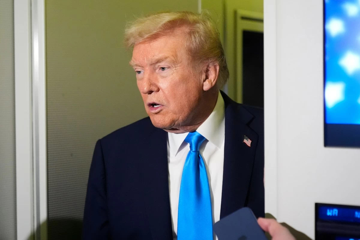 President Donald Trump speaks with reporters aboard Air Force One at Al Udeid Air Base in Doha, Qatar, Saturday, Oct. 25, 2025. (AP Photo/Mark Schiefelbein)