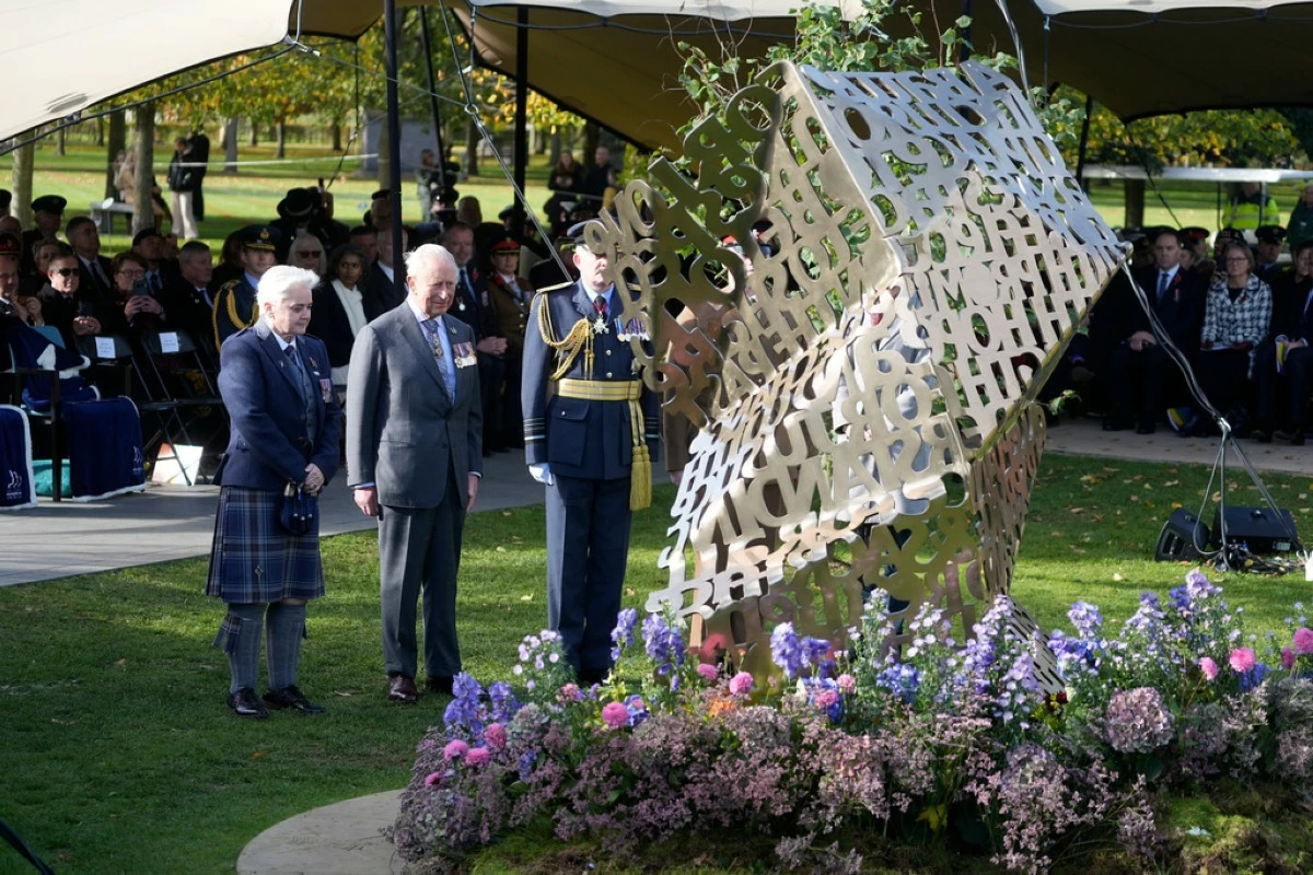 King Charles III stands during a visit to the National Memorial Arboretum in Alrewas, Staffordshire, for the dedication ceremony of the LGBT  Armed Forces memorial, the UK's first national memorial commemorating LGBT  people who have served and continue to serve in the military, Monday, Oct. 27, 2025. (Peter Byrne/PA via AP)