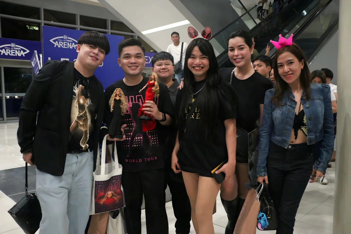 Fans show off their dedication to Mariah Carey with their merchandise and customized dolls.