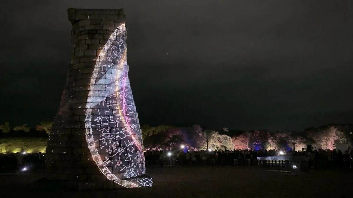 Visitors watch a media art show projected onto Cheomseongdae in Gyeongju, North Gyeongsang Province, Oct. 23. (Photo courtesy of Gyeongju City)