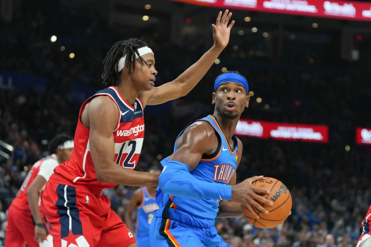 Oklahoma City Thunder guard Shai Gilgeous-Alexander, right, looks for an opening around Washington Wizards guard Tre Johnson, left, during the second half of an NBA basketball game, Thursday, Oct. 30, 2025, in Oklahoma City. (AP Photo/Kyle Phillips)