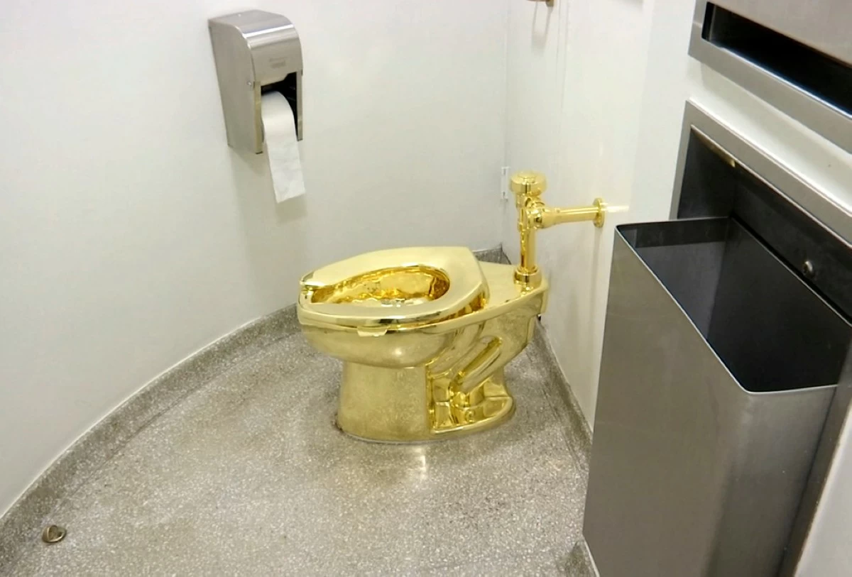 FILE - This Sept. 16, 2016 file image made from a video shows the 18-karat toilet, titled "America," by Maurizio Cattelan in the restroom of the Solomon R. Guggenheim Museum in New York. (AP Photo, File)