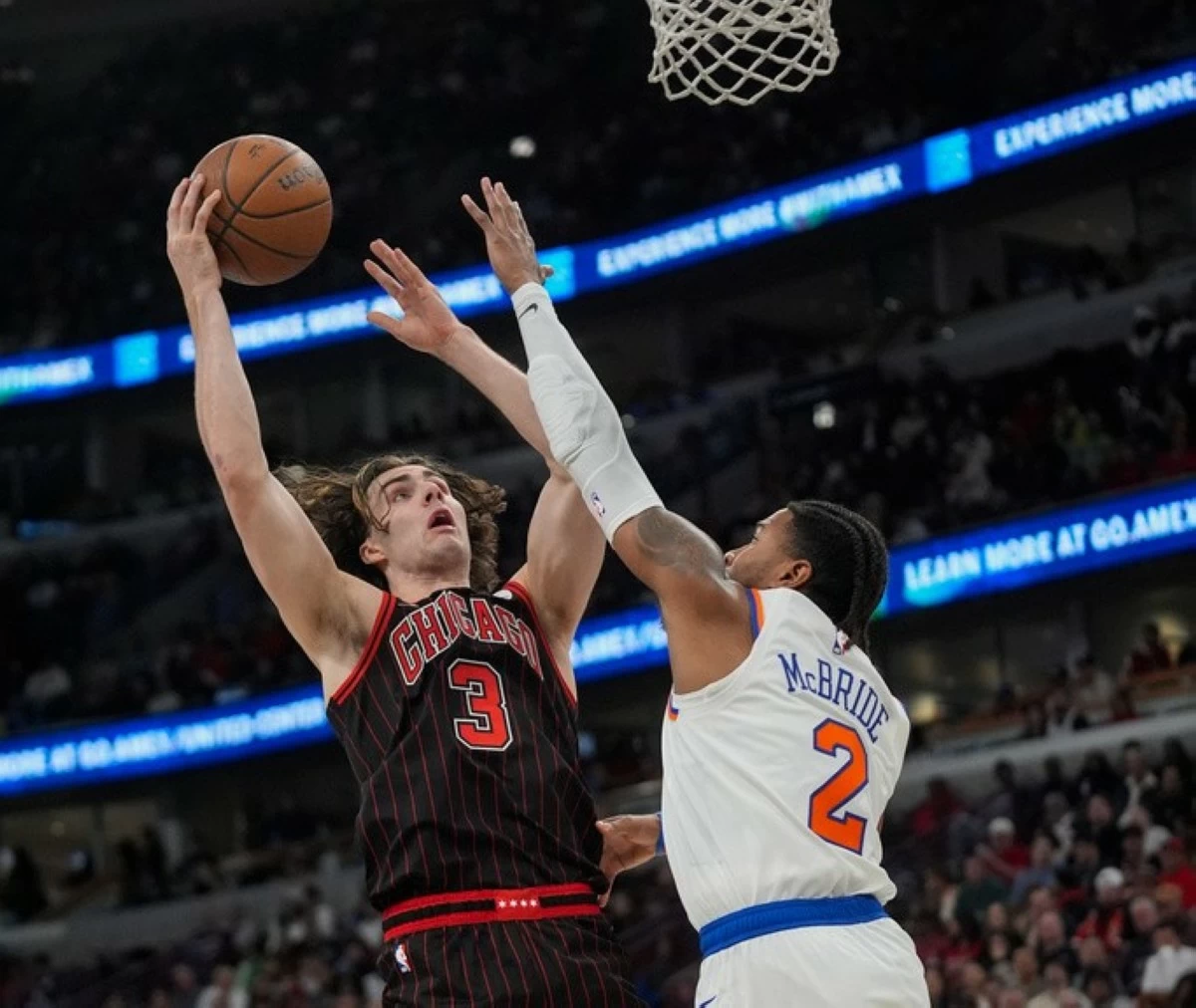 New York Knicks guard Miles McBride (2) tries to block Chicago Bulls guard Josh Giddey (3) who goes up to shoot during the second half of an NBA Cup basketball game Friday, Oct. 31, in Chicago. (AP Photo/Erin Hooley)
