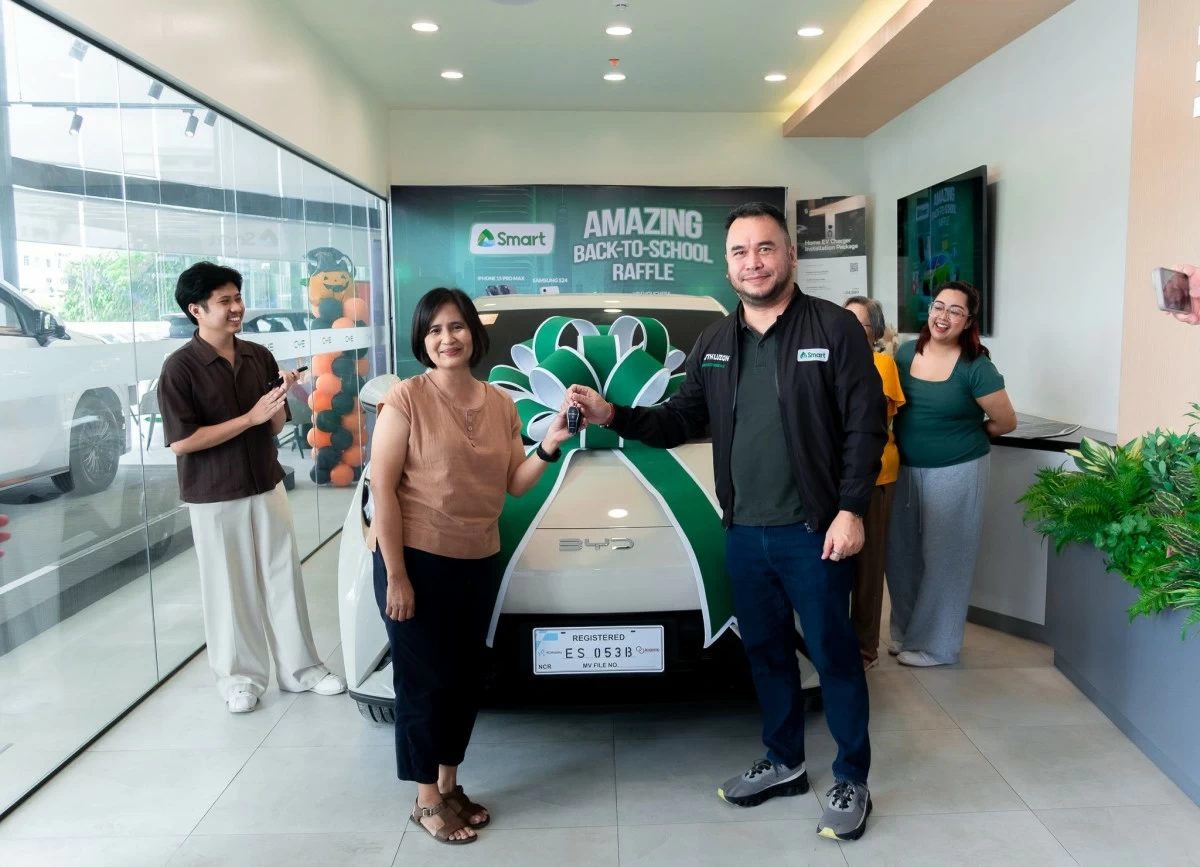 MARISSA ALVIOR receives the keys to her brand new BYD Seagull from Smart AVP Alexis Winters. Photo shows Marissa's family in the background celebrating Marissa’s early Christmas win.