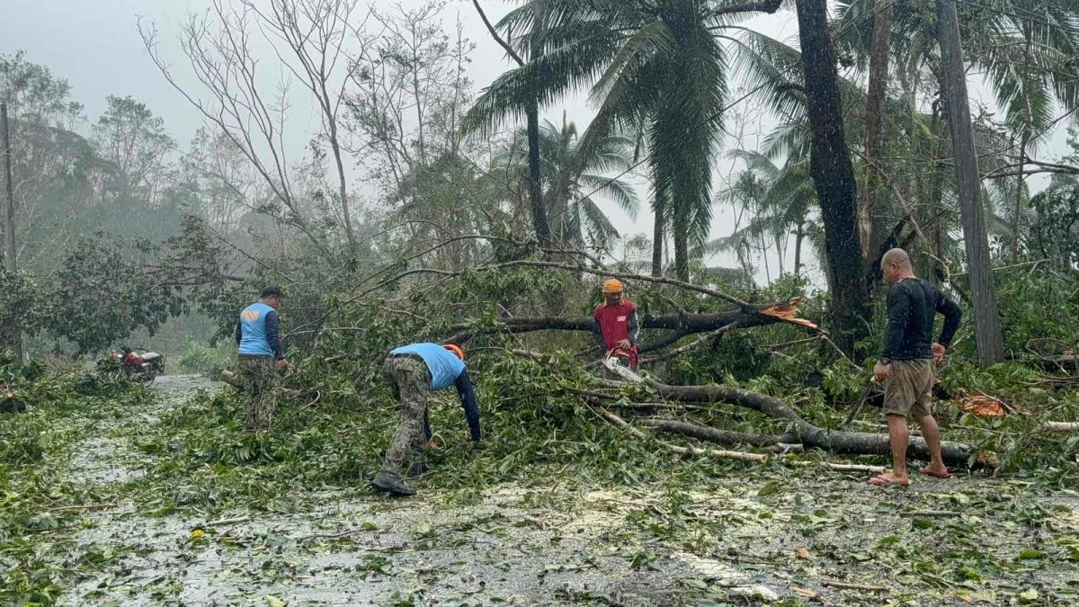 POLICE clear debris from tropical cyclone 'Tino' in Silago, Southern Leyte. (Marie Marticio)