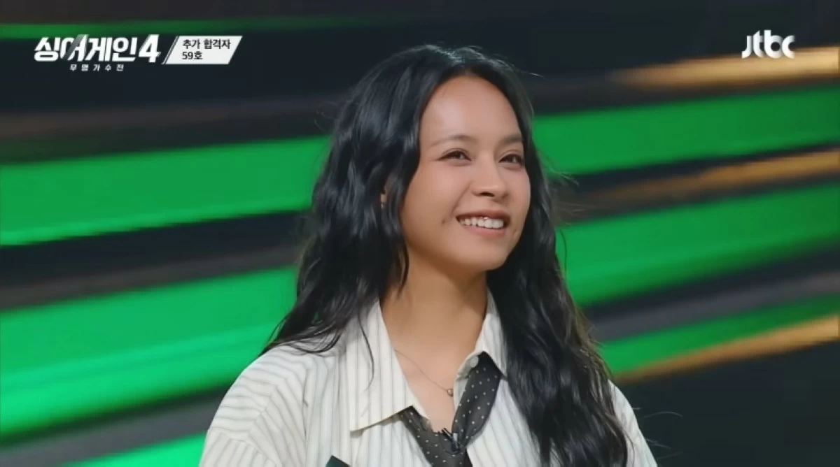 Filipino singer Gwyn Dorado smiles after the judges announced that she passed the second round on 