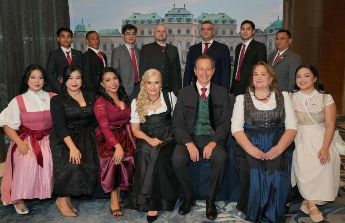 Ambassador Johann Brieger, Mme. Roswitha Brieger, and Consul Margit Loidolt pose with their official embassy family.