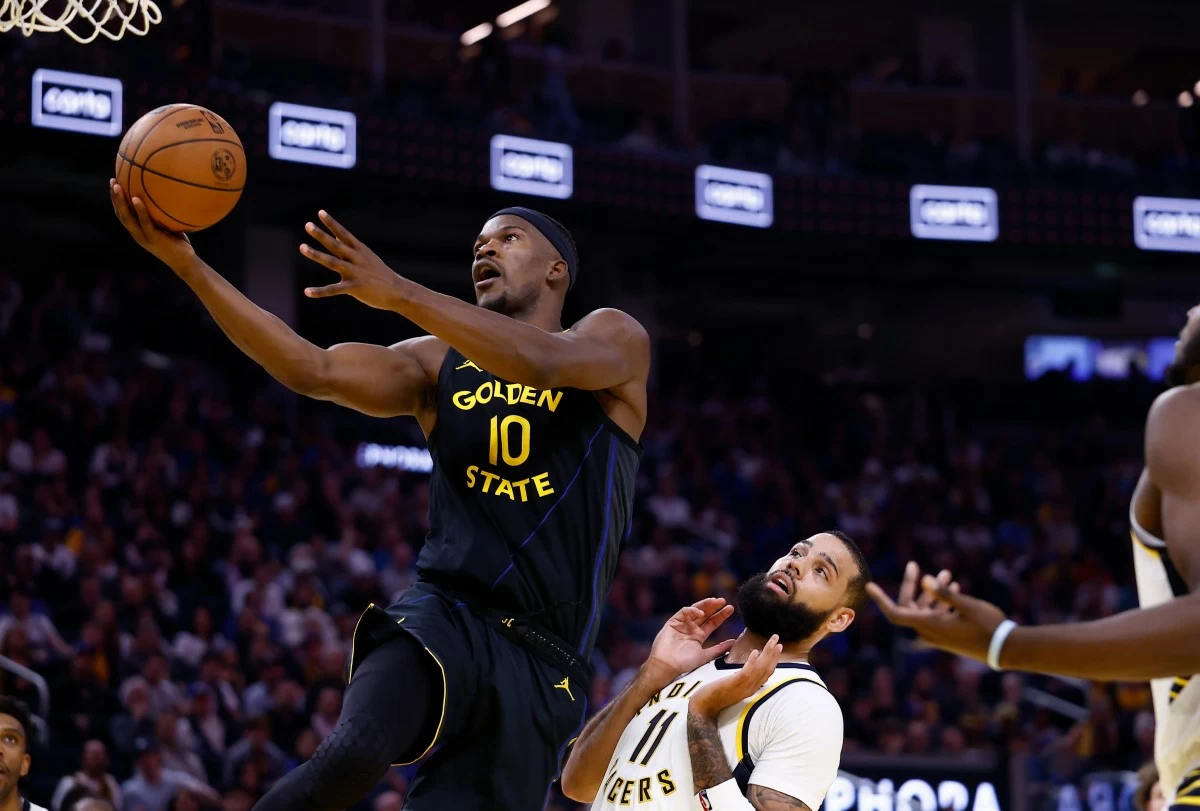 Golden State Warriors forward Jimmy Butler III (10) goes up to score against Indiana Pacers forward Cody Martin (11) during the first half of an NBA basketball game Sunday, Nov. 9, 2025, in San Francisco. (AP Photo/Kelley L Cox)