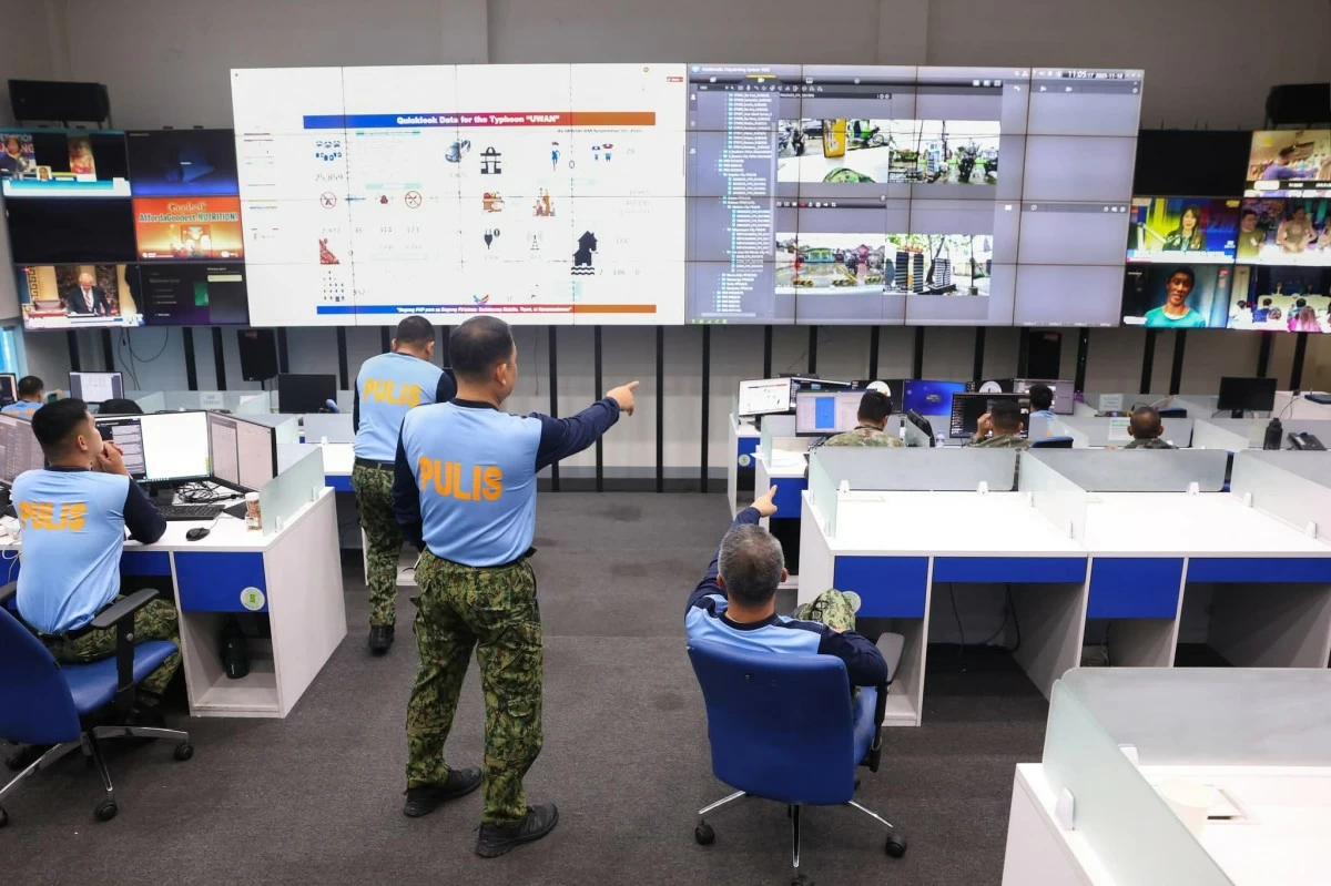 Police personnel keep watch over post-Typhoon Uwan operations at the PNP Command Center under the supervision of Acting Chief Lt. Gen. Jose Melencio Nartatez Jr. 