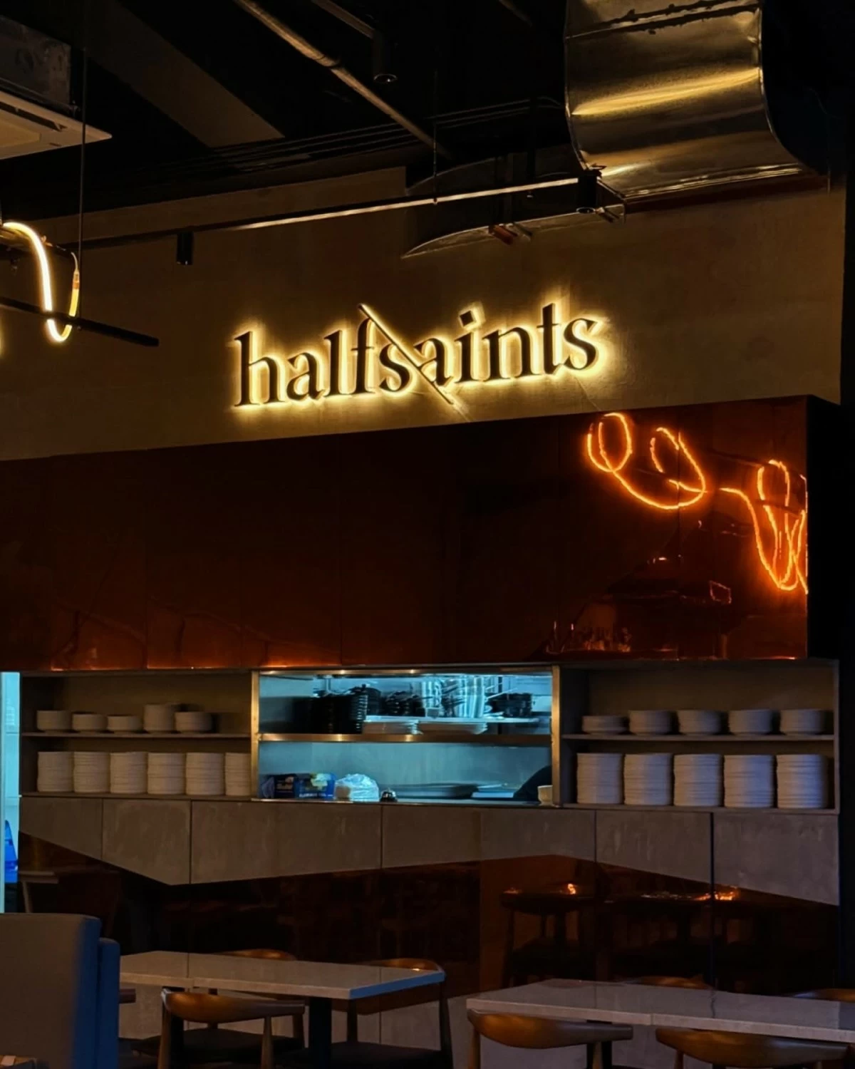 TEXTURED CALM  Half Saints BGC’s interiors blend stone, copper, and rope art in a space that feels both modern and lived-in.