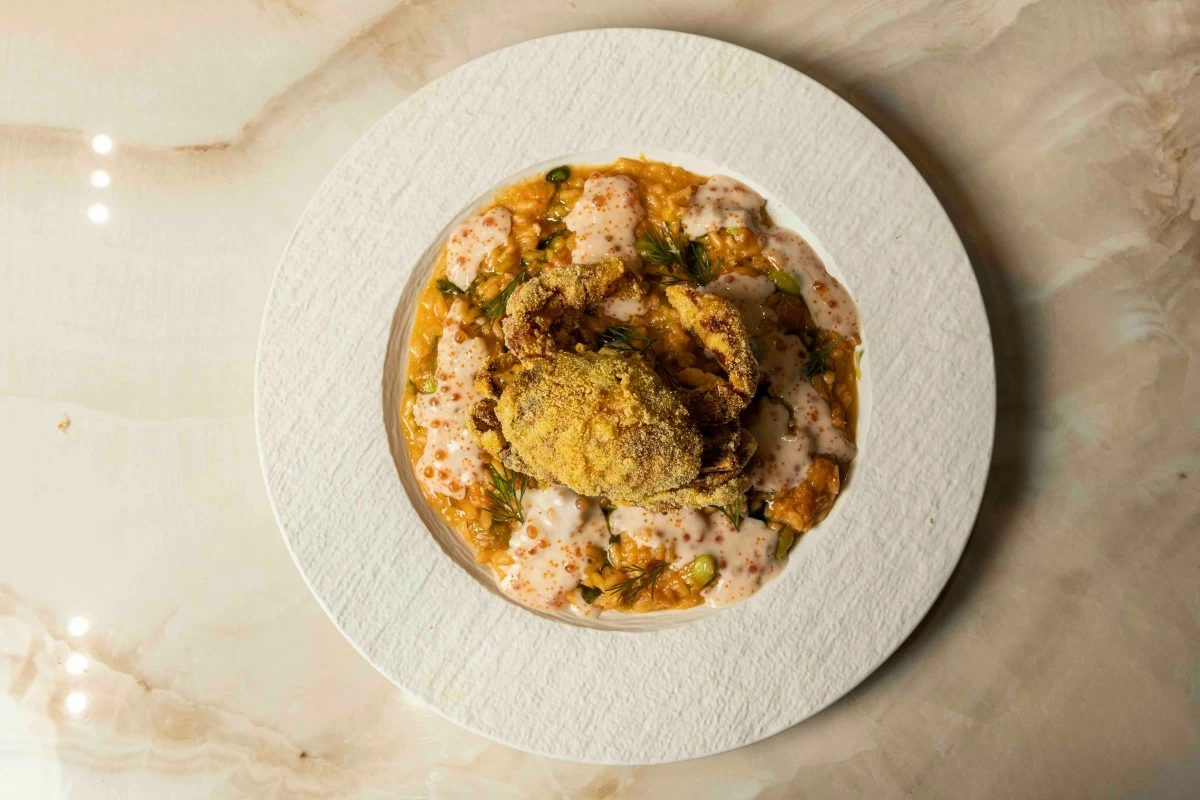 OCEAN COMFORT The Soft Shell Crab Risotto brings together taba ng talangka, edamame, ikura, and tobiko in a creamy, briny harmony.