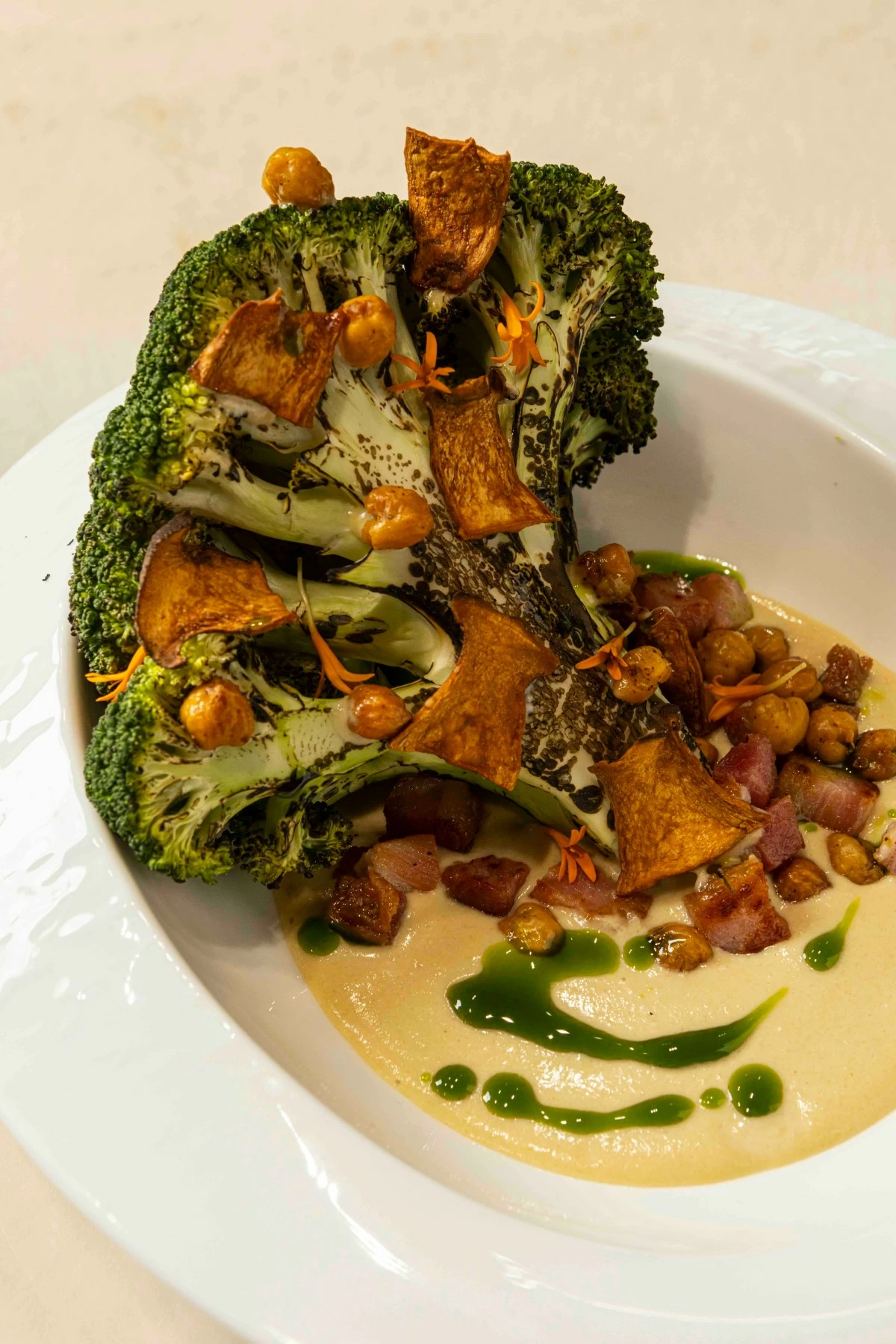GREEN REBIRTH  Half Saints reimagines the classic Caesar in the Caesar Tree, a lush medley of charred broccoli, shiitake, chickpeas, bacon, and Grana Padano that turns a familiar salad into an edible landscape.