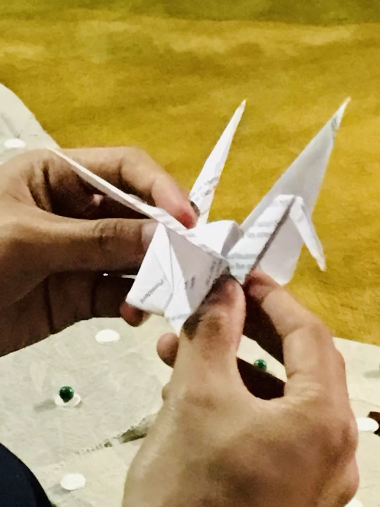 Folding paper cranes as part of the Julia Buencamino Project program. 