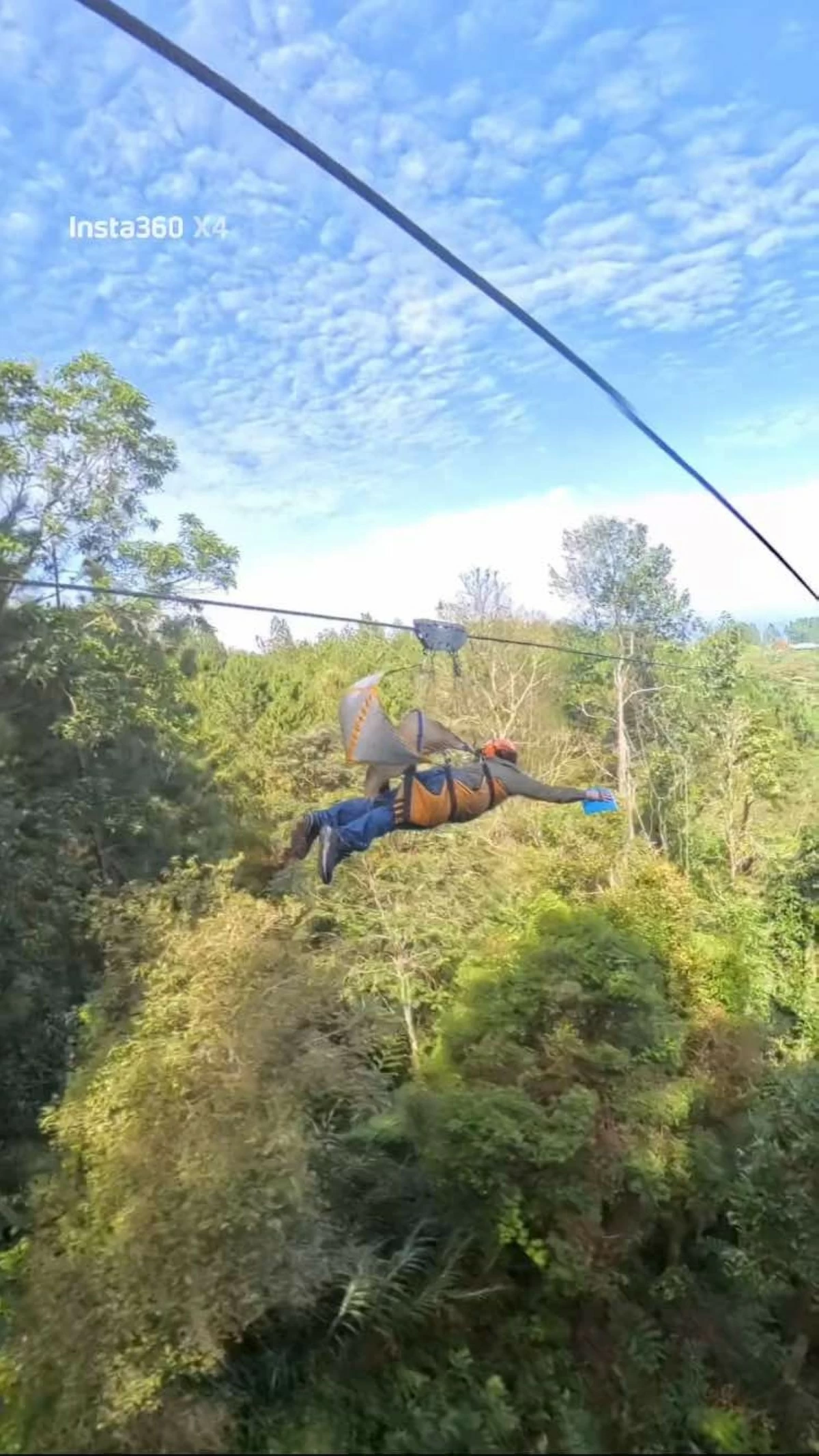 TAKING FLIGHT The author zips by and enjoys the sights offered by Asia's longest dual zipline. (Photo courtesy of Jomar Alameda)