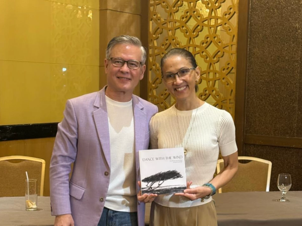 Raymond Lauchengco, with his actress-sister, Menchu Lauchengco, holding a copy of his book 'Dance With The Wind'

