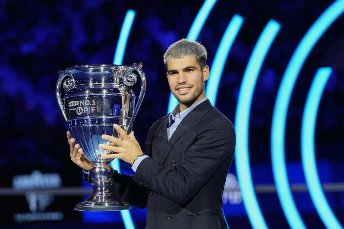 Spain's Carlos Alcaraz holds the trophy for finishing the year ranked No. 1 as ATP world best player during the ATP World Tour Finals, in Turin, Italy, Friday, Nov. 14, 2025. (AP Photo/Antonio Calanni)