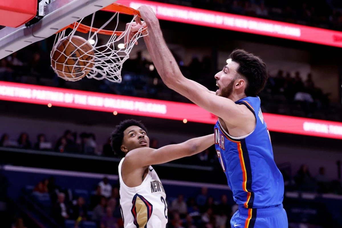 Oklahoma City Thunder center Chet Holmgren, right, slam-dunks as Oklahoma City Thunder guard Ajay Mitchell, left, defends during the third quarter of an NBA basketball game, Monday, Nov. 17, 2025, in New Orleans. (AP Photo/Butch Dill)