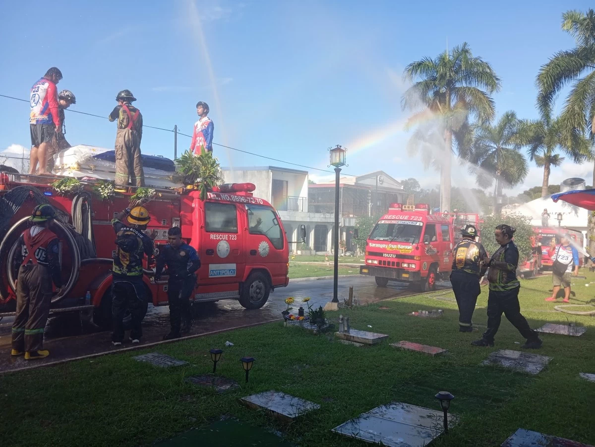 Water soars in front and above the firetruck bearing the coffin of Magpusao at the cemetery grounds (Photo by Nel Andrade/Manila Bulletin)