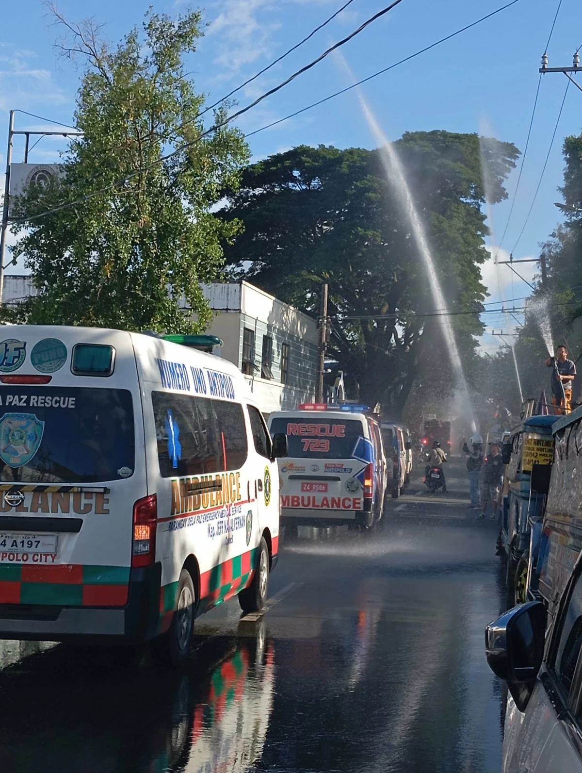 Ambulances line-up on the street leading to the cemetery (Photo by Nel Andrade/Manila Bulletin)