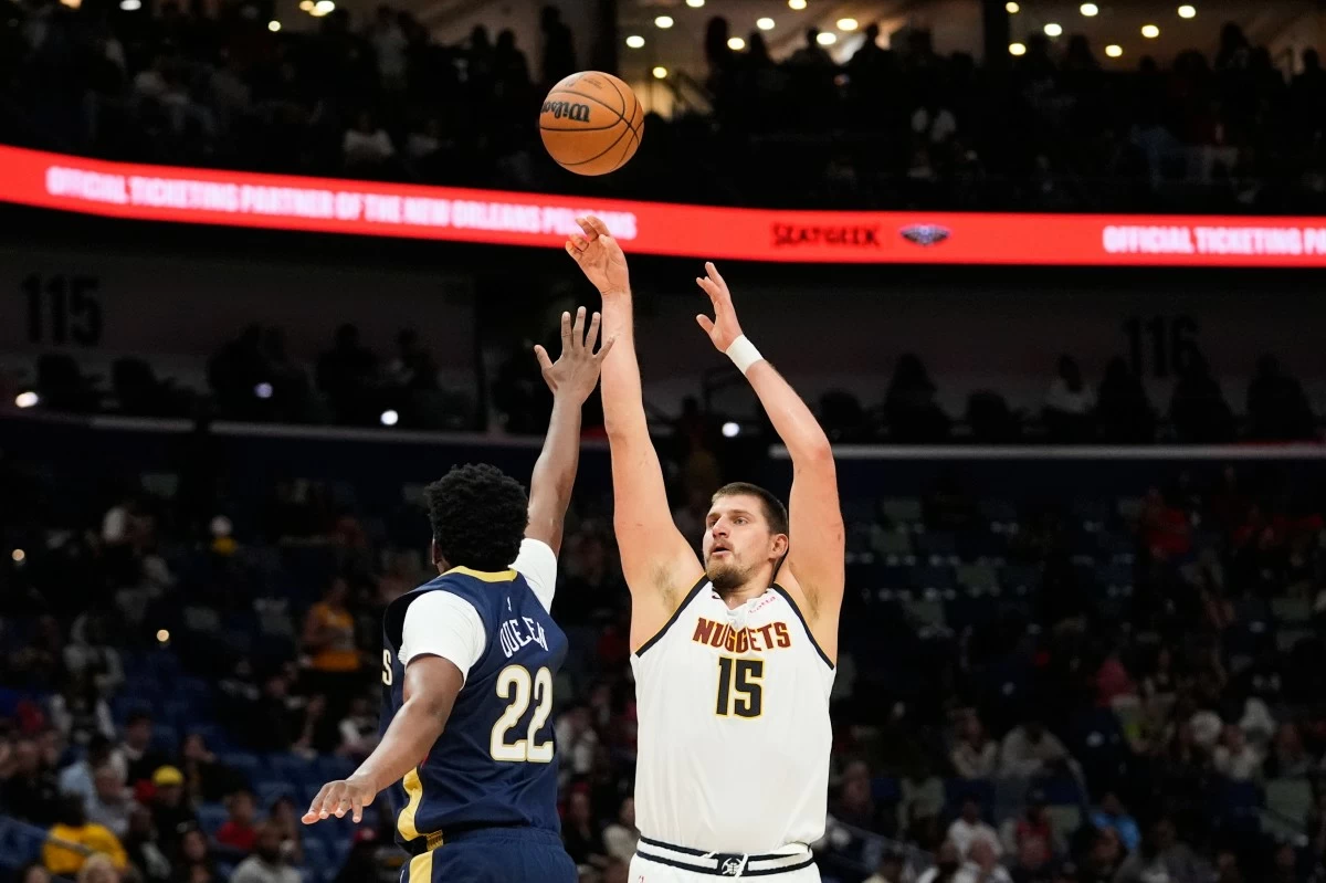Denver Nuggets center Nikola Jokic (15) shoots over New Orleans Pelicans center Derik Queen (22) shoots against in the second half of an NBA basketball game, Wednesday, Nov. 19, 2025, in New Orleans. (AP Photo/Gerald Herbert)