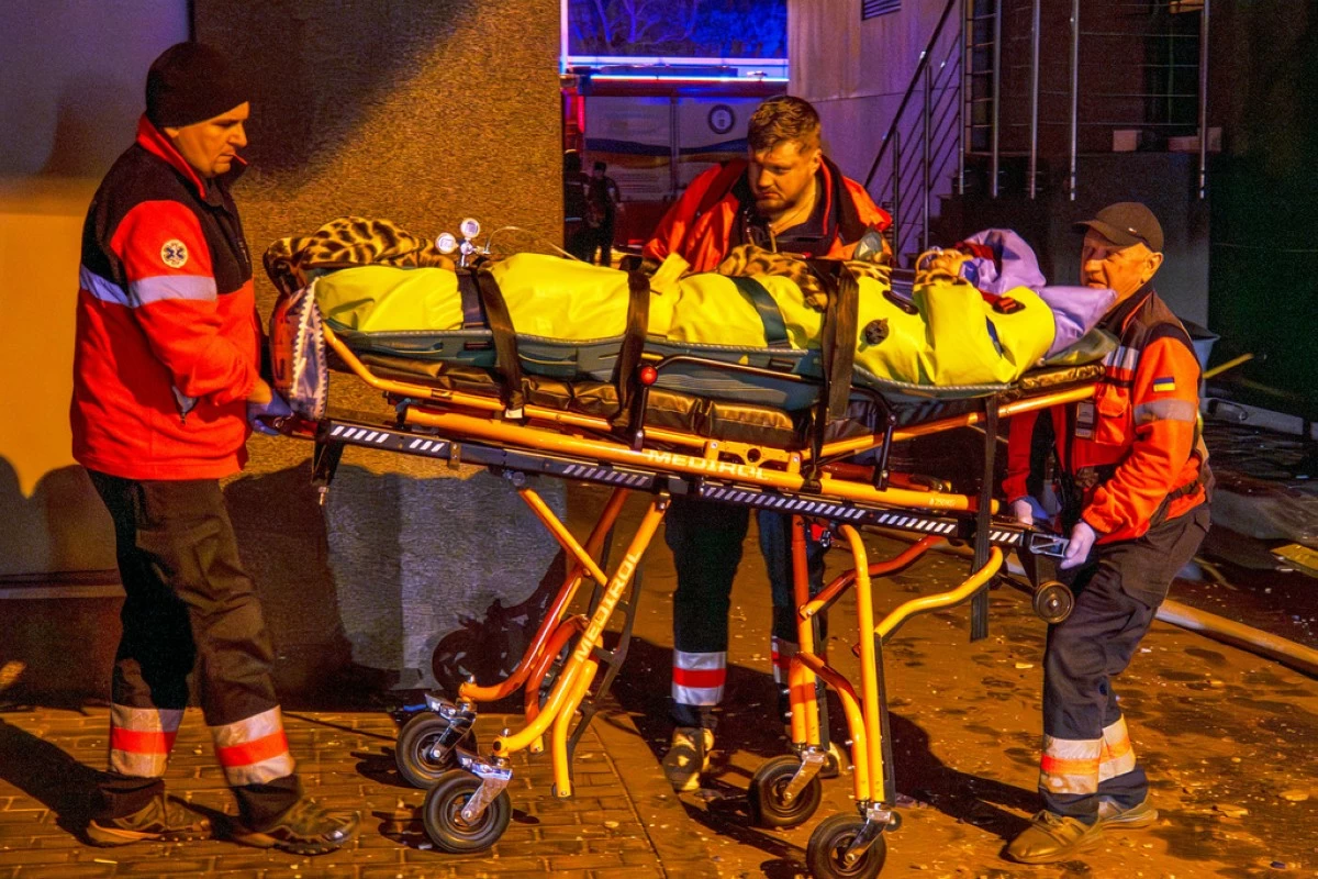 Rescue workers carry a person from a residential building following a Russian attack in Kyiv, Ukraine, Tuesday, Nov. 25, 2025. (AP Photo/Dan Bashakov)