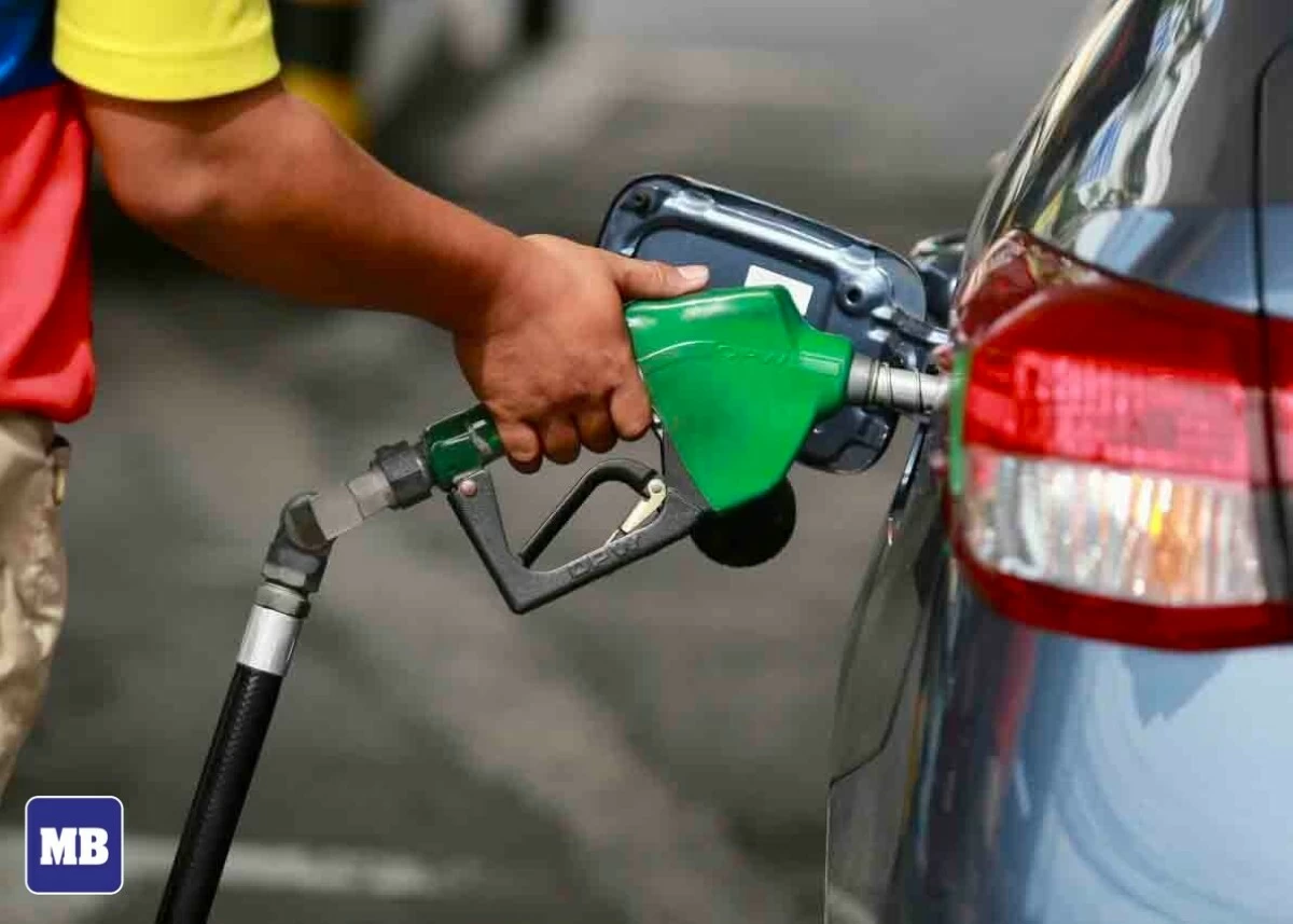 At a Quezon City gas station, a pump attendant fills a car's fuel tank. This week, the cost of petroleum products has risen, a direct result of escalating geopolitical tensions in the Middle East.
