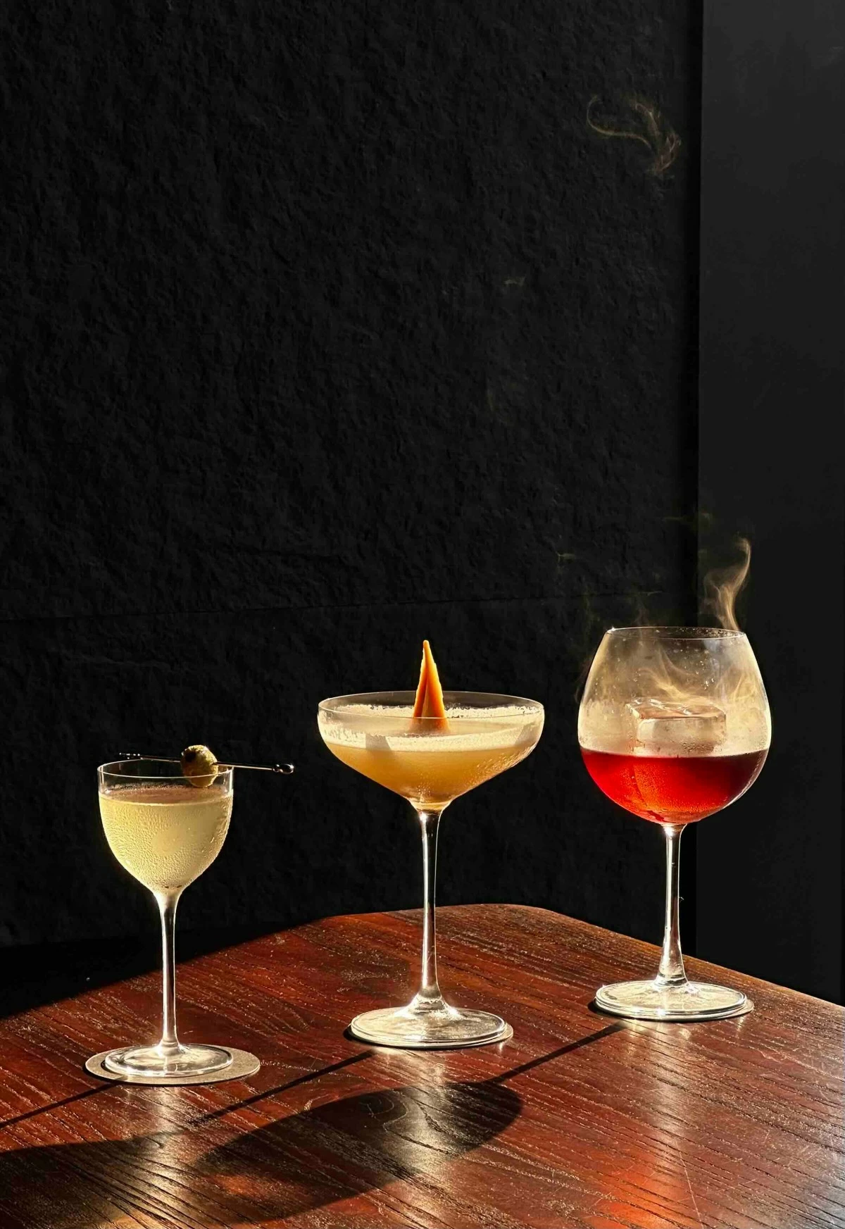 TRIPLE SIP Three cocktails from the Trilogy menu, each with its own character, from sharp and herbal to sweet and smoky, lined up for a night that moves in three steady acts.