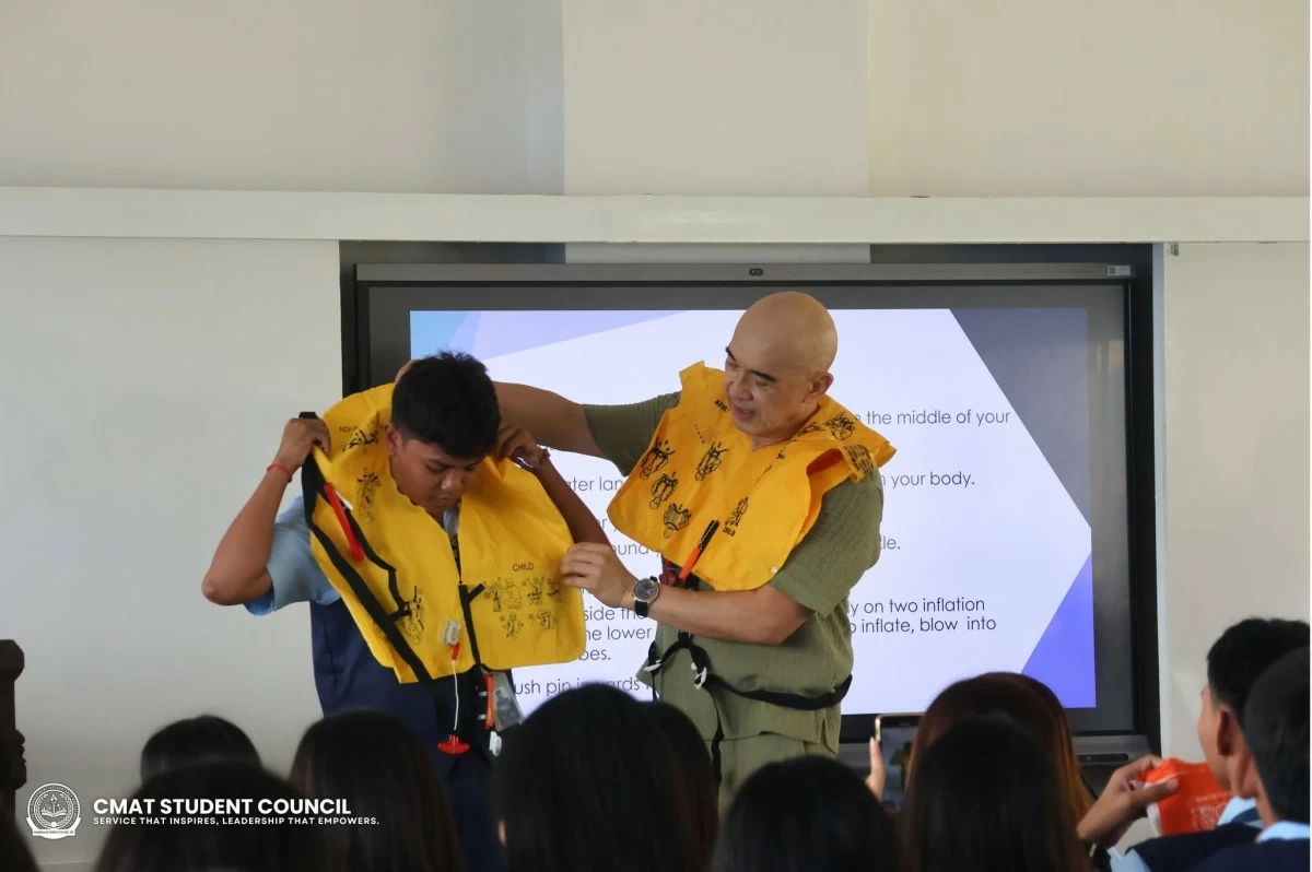Bong Quintana assists a participant with the lifevest