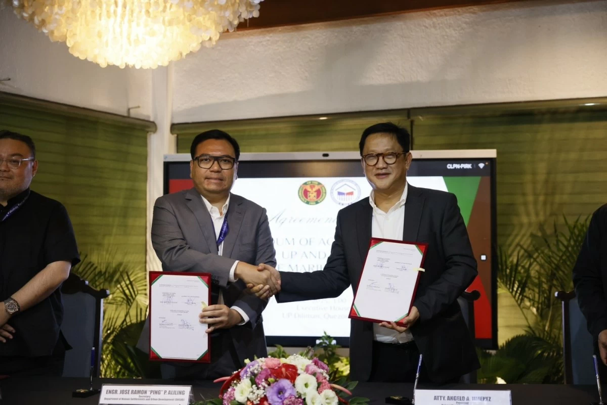 DHSUD Secretary Jose Ramon Aliling and UP President Angelo Jimenez sign an agreement that will pave the way for the construction of affordable rental houing project inside the UP Diliman Campus in Quezon City. (photo: DHSUD)