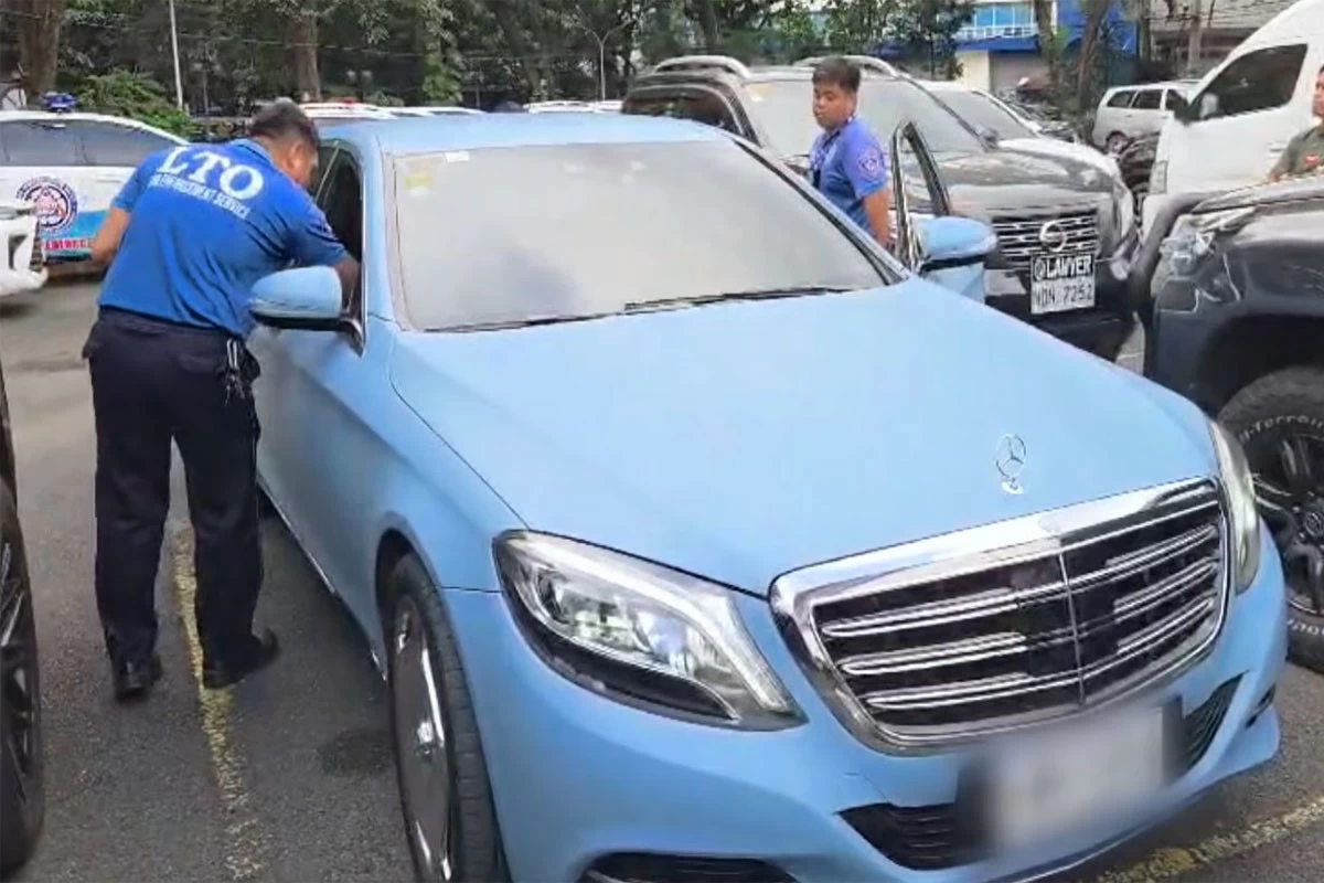 LTO agents check on a luxury vehicle that was intercepted in Makati City over suspicion of smuggling. 