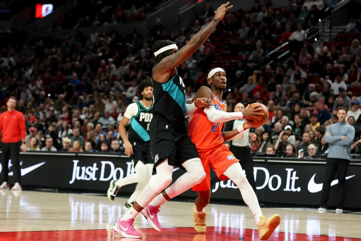 Oklahoma City Thunder guard Shai Gilgeous-Alexander (2) drives to the basket ahead of Portland Trail Blazers center Robert Williams III (35) during the second half of an NBA basketball game, Sunday, Nov. 30, 2025, in Portland, Ore. (AP Photo/Amanda Loman)