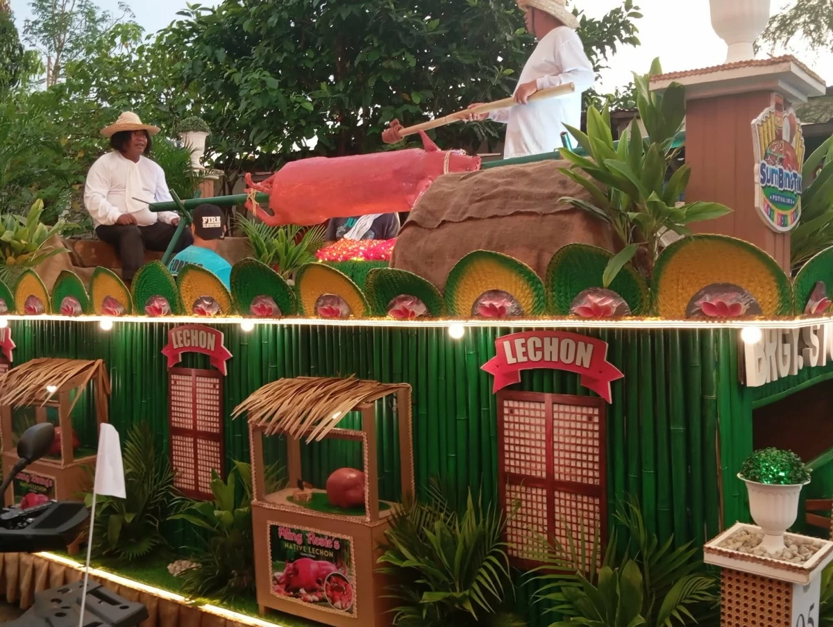 A man acts as a lechon griller on the float which has a giant roasted pig (photo by Nel Andrade/Manila Bulletin)