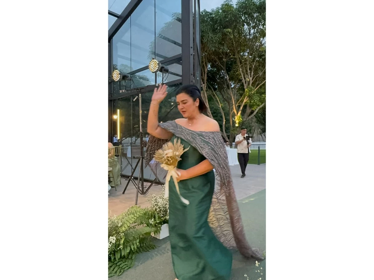 Nadia Montenegro, mother of the bride, praising God as she walks down the aisle.