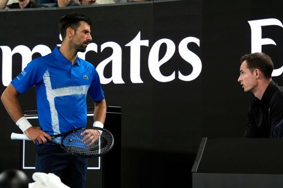 FILE - Novak Djokovic, left, of Serbia, talks with his coach Andy Murray during his first round match against Nishesh Basavareddy, of the United States, at the Australian Open tennis championship in Melbourne, Australia, Jan. 13, 2025. (AP Photo/Asanka Brendon Ratnayake, File)