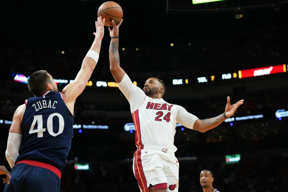 Miami Heat guard Norman Powell (24) goes to the basket as Los Angeles Clippers center Ivica Zubac (40) defends during the first half of an NBA basketball game, Monday, Dec. 1, 2025, in Miami. (AP Photo/Lynne Sladky)