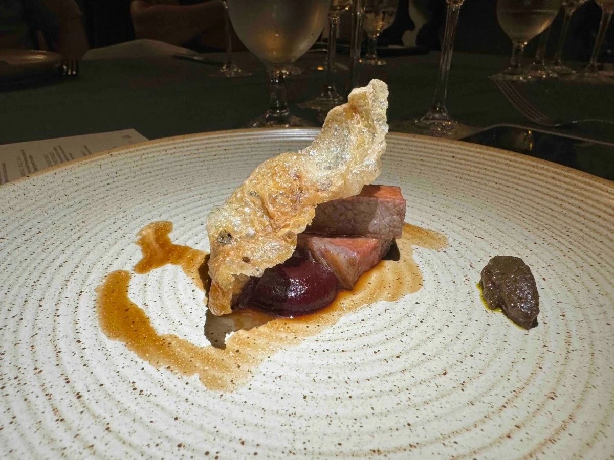 WAGYU PLATE The Wagyu-Smoked Beetroot-Fermented Root Vegetables dish showcases A5 Wagyu served with smoked beetroot purée and fermented root vegetable paste.