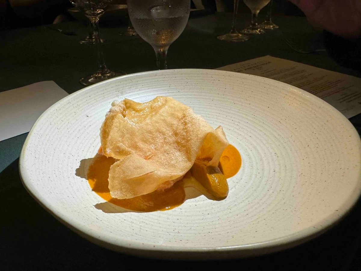 TROUT COURSE The Fjord Trout-Carrot-Coffee dish features butter-poached trout paired with roasted carrot purée, taba na talangka sauce, and notes of local Arabica coffee.