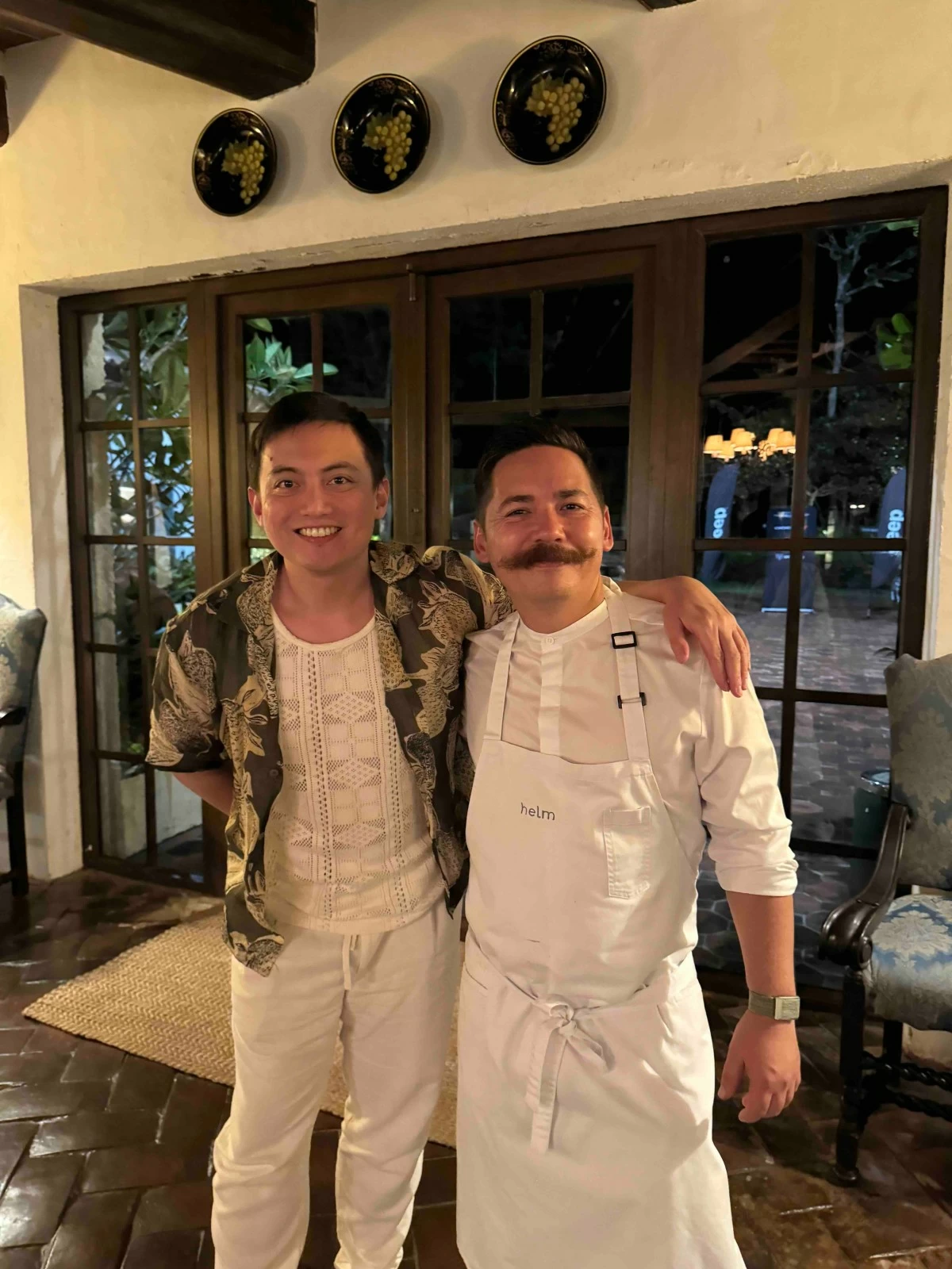 TASTEMAKER NIGHT The author stands with Chef Josh Boutwood during the one-night-only dinner at Toscana Village on Balesin Island.