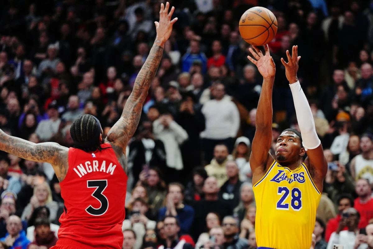 Los Angeles Lakers' Rui Hachimura (28) shoots the winning basket over Toronto Raptors' Brandon Ingram (3) during second-half NBA basketball game action in Toronto, Thursday, Dec. 4, 2025. (Frank Gunn/The Canadian Press via AP)