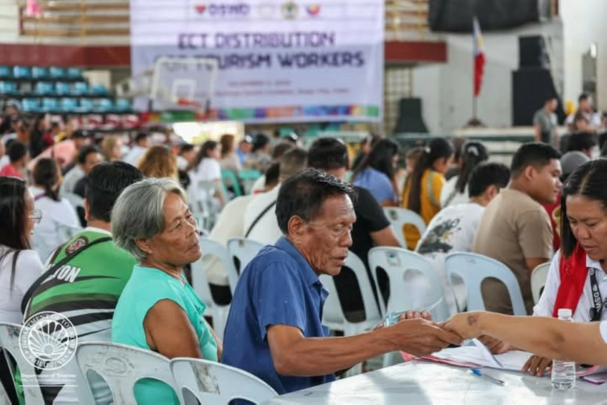 Tourism workers receive financial assistance during the Department of Tourism (DOT)-led Emergency Cash Transfer distribution in Bogo City, Cebu on December 4, 2025. (Photo courtesy of DOT)