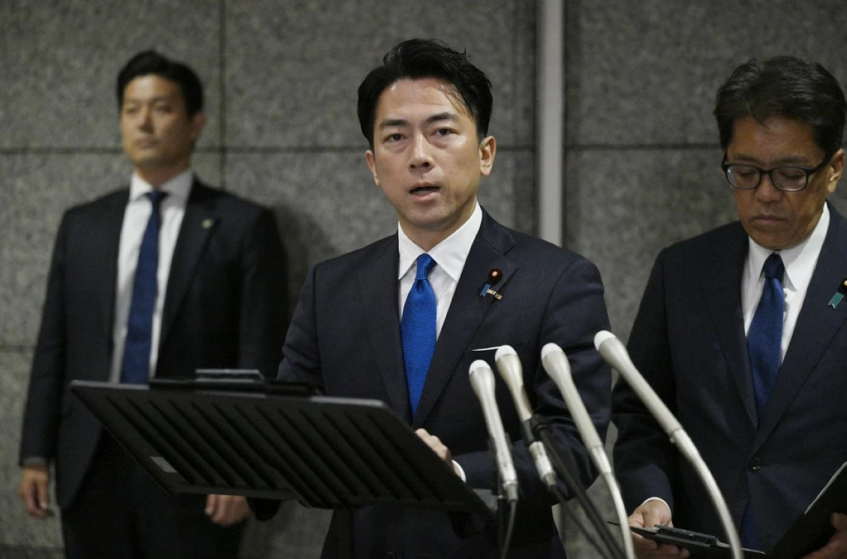 Japan's Defense Minister Shinjiro Koizumi, center, speaks to the media, as Japan announced that a Chinese military aircraft locked its radar on Japanese jets,  at the ministry in Tokyo, Sunday, Dec. 7, 2025. (Kyodo News via AP)