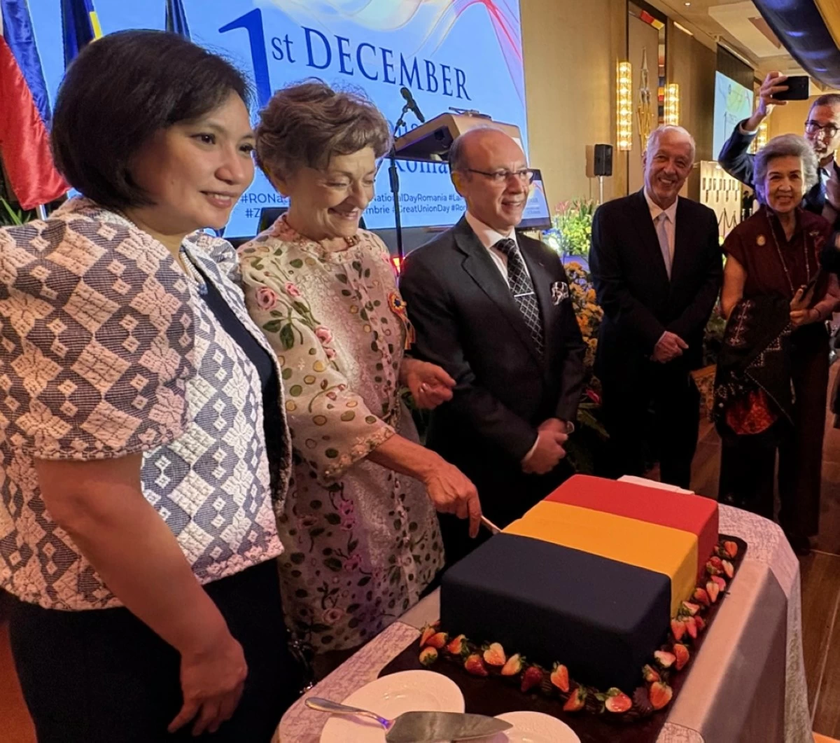 The symbolic act of cutting the cake signifies solidarity and the strengthening of bilateral relations between Romania and the Philippines