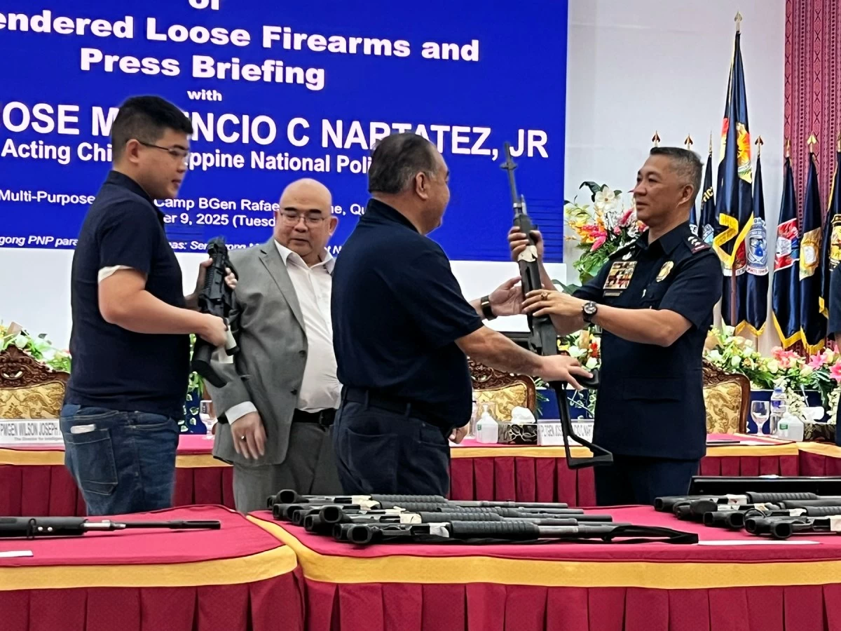 Acting PNP chief Lt. Gen. Jose Melencio C. Nartatez, Jr. accepts several high-powered firearms that were turned over by a gun collector to the police during a ceremony at Camp Crame in Quezon City on Tuesday, Dec. 9, 2025. (photo: PNP) 